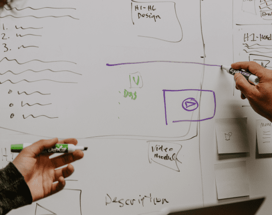 People working at a white board