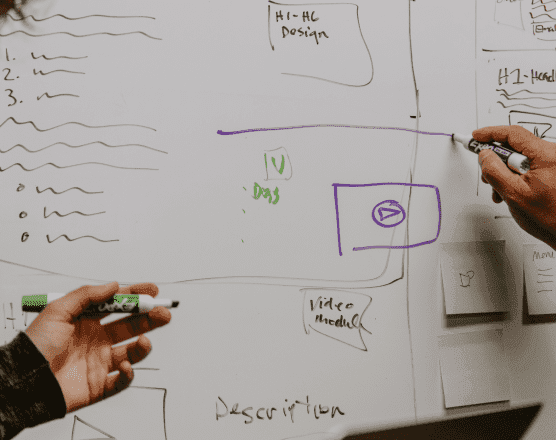 People working at a white board
