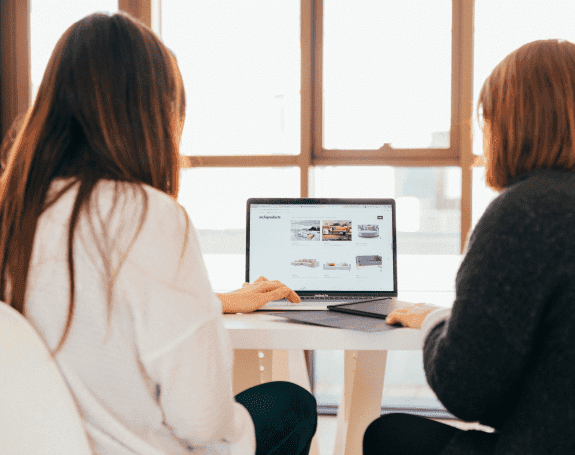 Two people working at computer