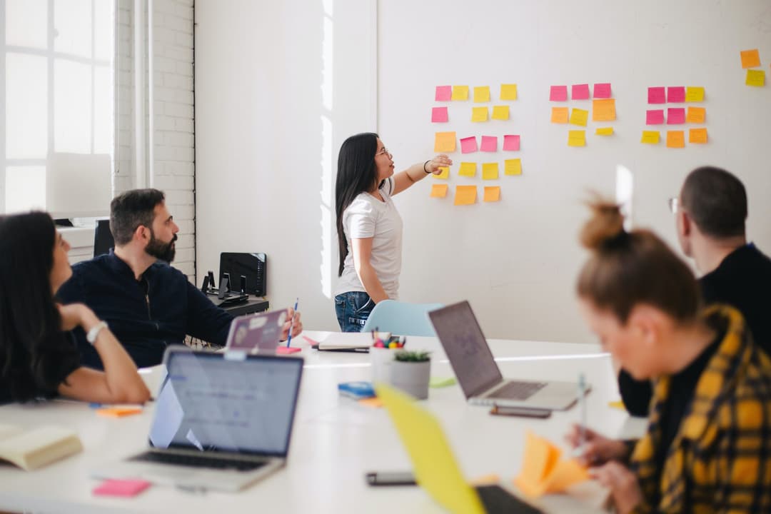 Person at whiteboard in a meeting