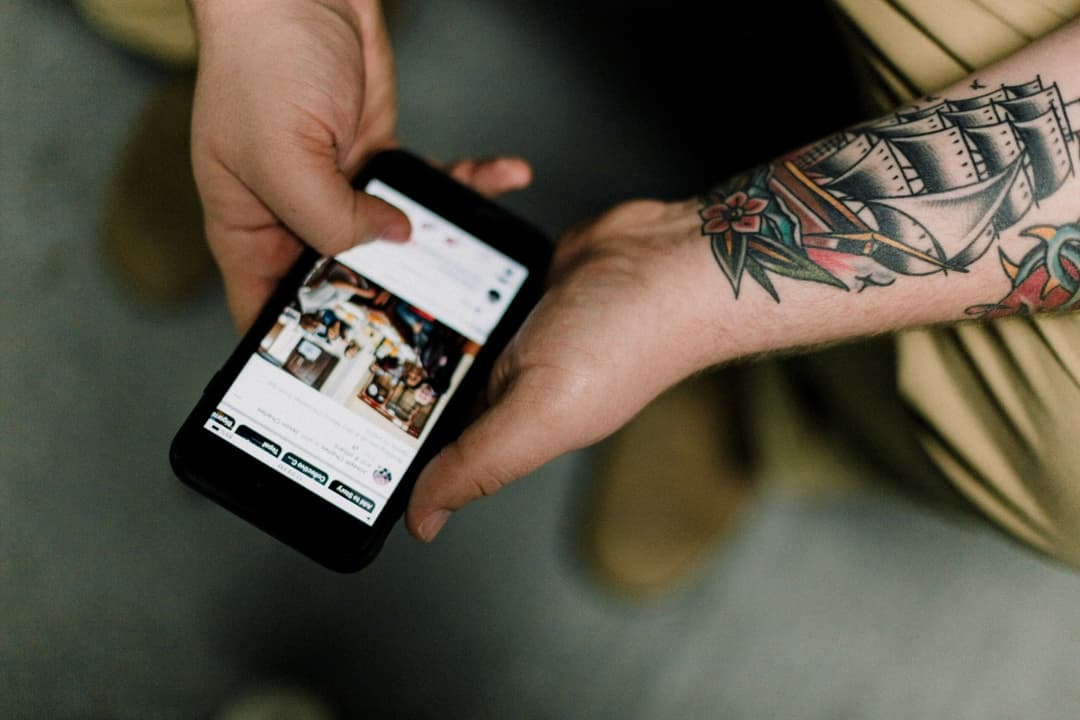 Man holding phone looking at website